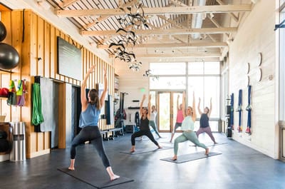 Residents participating in a yoga class in an activity room