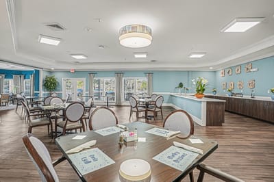 Bright dining room with tables set for meals