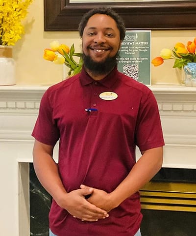 Staff member posing in a decorated lobby area