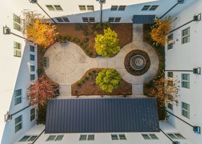 Aerial view of a landscaped courtyard with trees and pathways