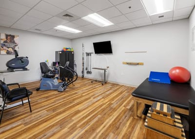 Physical therapy room with exercise equipment and accessories