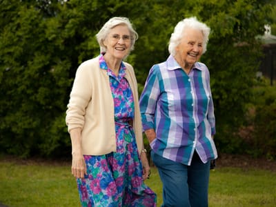 Two elderly women enjoying a walk outdoors