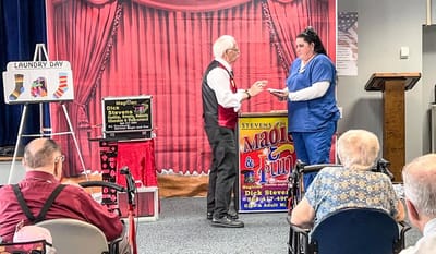 Residents enjoying a magic show performance