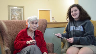 A senior resident and a volunteer enjoying an activity
