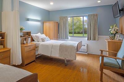 Private resident room with bed and window view