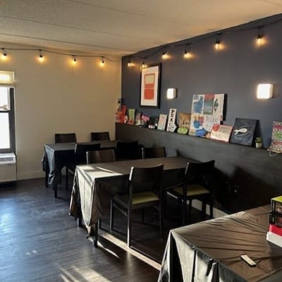 Bright dining room with tables and artwork on the wall