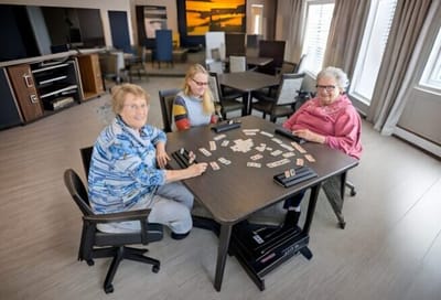 Residents enjoying a game together in a common area