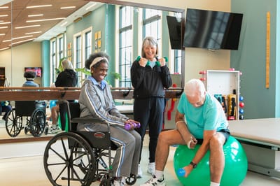 Residents engaging in a fitness activity in a gym area