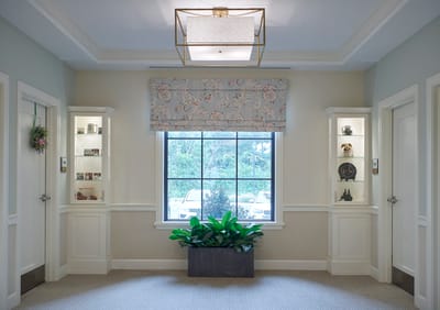 Bright corridor with decorative window and plants