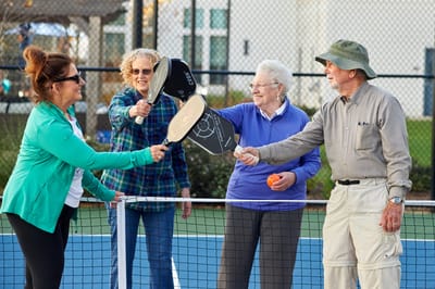 Residents enjoying a game of pickleball outdoors