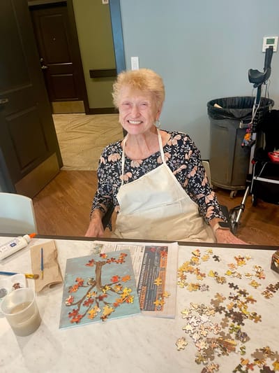Resident enjoying a puzzle activity in a common area