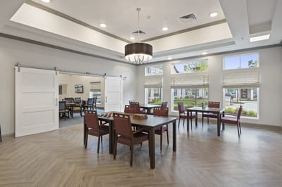 Bright common area with dining tables and seating