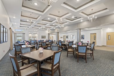 Bright dining room with tables and flowers