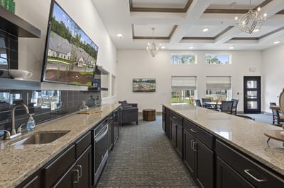 Bright common area with a modern kitchen and seating