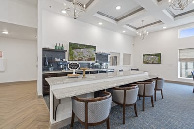 Bright common area with a modern kitchen and seating