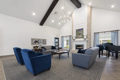 Bright common area with comfortable seating and a piano