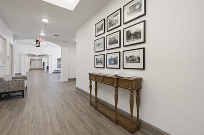 Interior hallway with framed photographs and wooden table