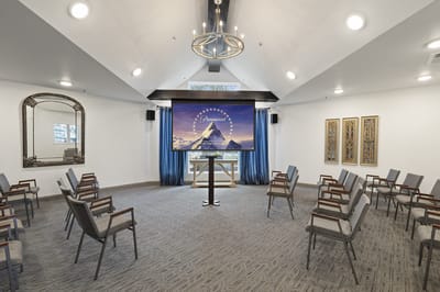 Interior view of a common area with chairs and a screen