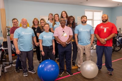 Staff and residents participating in a group exercise activity