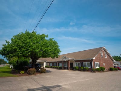 Exterior view of the assisted living facility with green landscaping