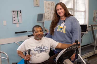 Resident and staff member in a rehabilitation room
