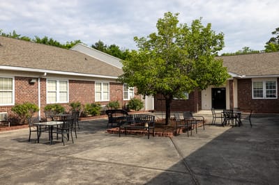 Outdoor seating area with tables and a tree