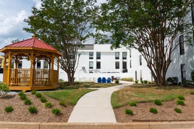 Pathway through landscaped outdoor space with gazebo