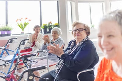 Residents participating in an indoor activity, clapping together