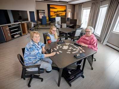 Residents playing cards in a common area