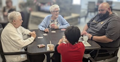 Residents playing cards in a common area