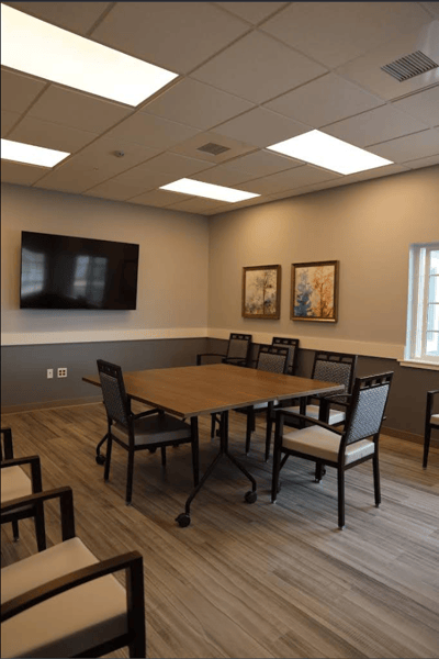 Bright activity room with tables and chairs