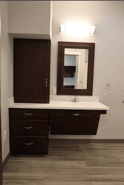 Interior view of a bathroom with storage and a mirror