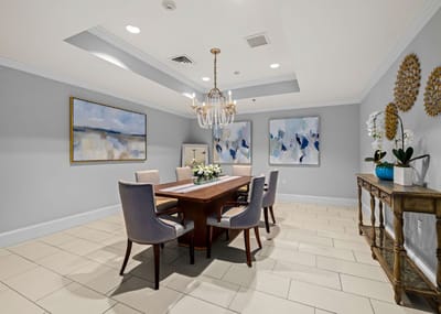 Elegant dining room with a large wooden table and art