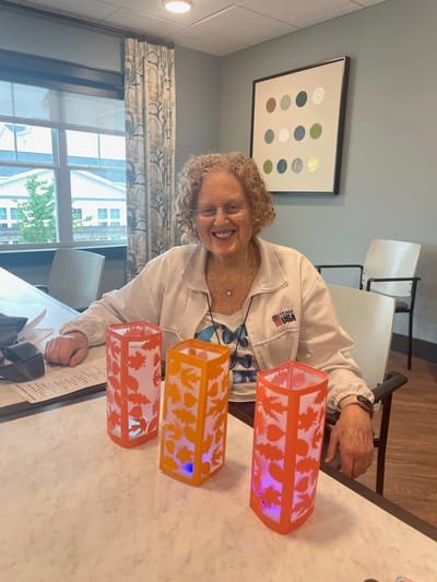Resident enjoying a creative activity in the common area