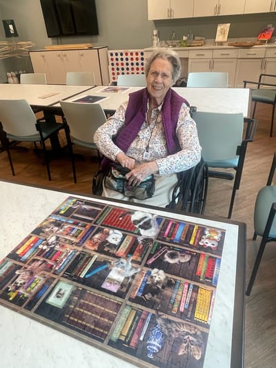 Resident in a common area with a colorful puzzle