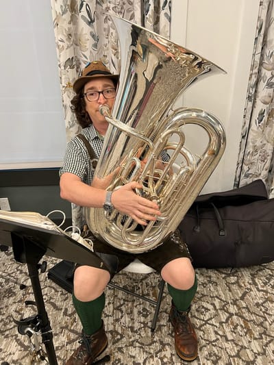 A musician playing tuba during a facility event