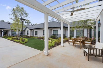 Outdoor patio area with seating and gardens
