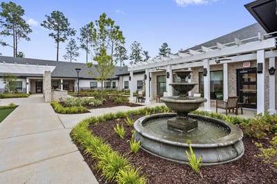 landscaped courtyard with a fountain and seating