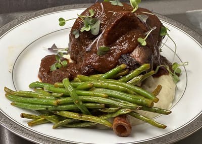 Plated meal of slow-cooked beef and green beans