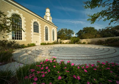 Serene outdoor space with a labyrinth and flowers