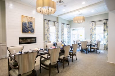 Bright dining room with tables and chairs set for meals