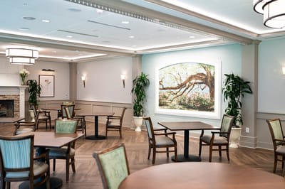 Bright common area with tables and artwork