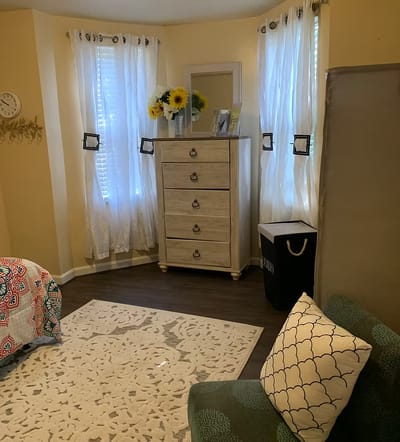 Cozy resident room with floral decor and natural light