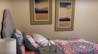 Cozy resident room with comfortable bedding and decor