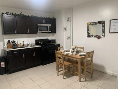 Cozy dining area with kitchen appliances and table settings