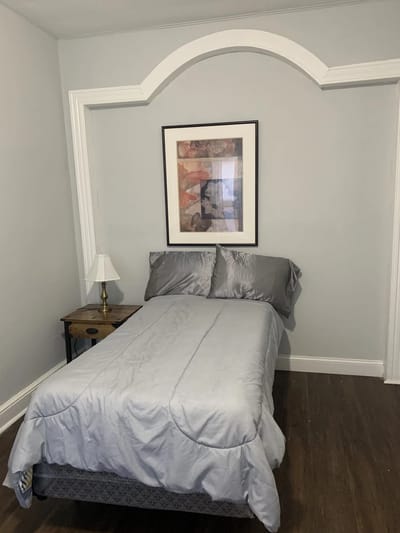 Cozy private resident room with bed and art