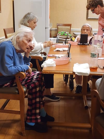 Residents engaged in an activity around a table
