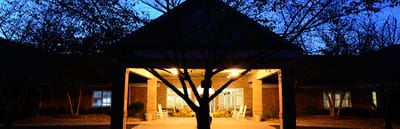 Entrance of the facility illuminated at dusk