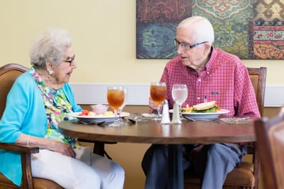 Residents enjoying a meal together in the dining room