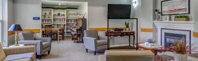 Cozy common area with seating and bookshelf